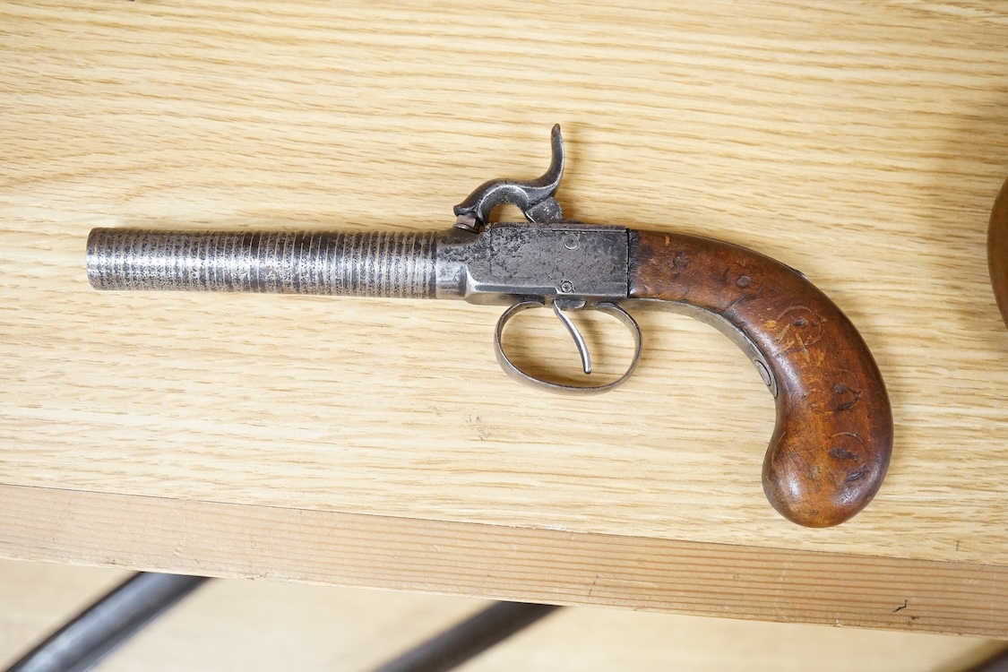 A boxlock percussion pocket pistol with turn off barrel inlaid with spiral brass wire for full length, plain frame and rounded walnut grip, probably Belgium made
